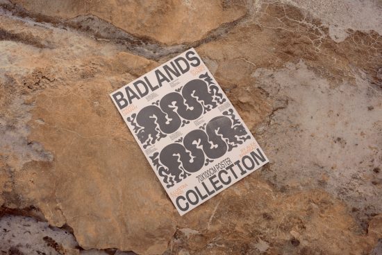 Vintage poster mockup featuring Badlands design on a textured rock surface perfect for graphic design portfolio presentations.